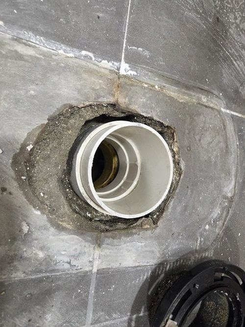 누수탐지 점검 결과를 정리한 기록지와 욕실 바닥 상태를 확인하는 장면