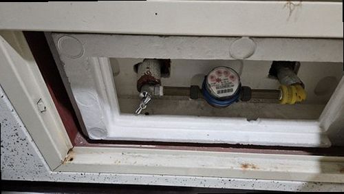 동작구 누수탐지 주방 싱크대 하부의 젖은 흔적과 벽면 배관 위치를 살피는 점검 장면