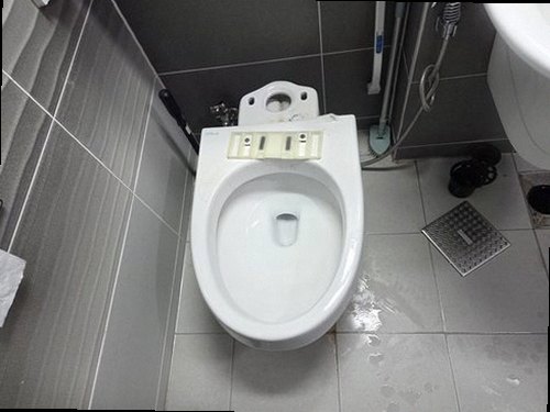 누수탐지 욕실 수전 아래 배관 연결부를 살펴보는 점검 장면